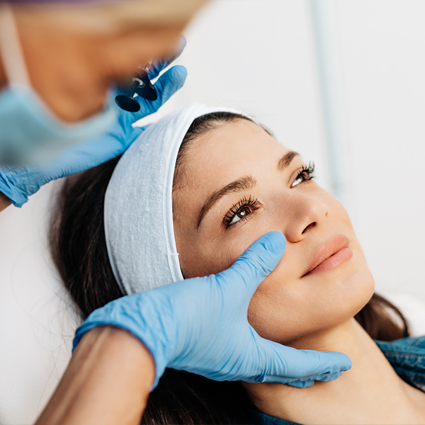 Attractive young woman is getting a rejuvenating facial injections at beauty clinic